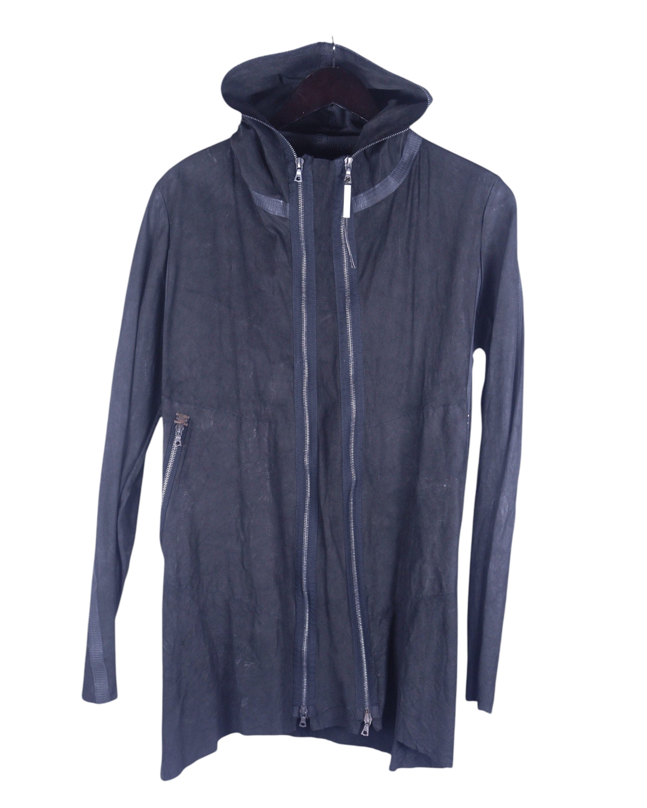 A black Isaac Sellam calfskin jacket with a hood, zipper, and long sleeves. Isaac Sellam black/charcoal/ink calfskin hooded jacket; longline leather coat/zip hoodie with twin vertical two-way zippers, high neck, slim sleeves, hidden pocket, raw/washed finish; matte silver hardware; regular fit, unisex; pairs with denim, tailoring, techwear; avant-garde, minimal, industrial; brand context: French artisanal label from Paris known for experimental leatherwork and architectural cuts; rare runway piece.