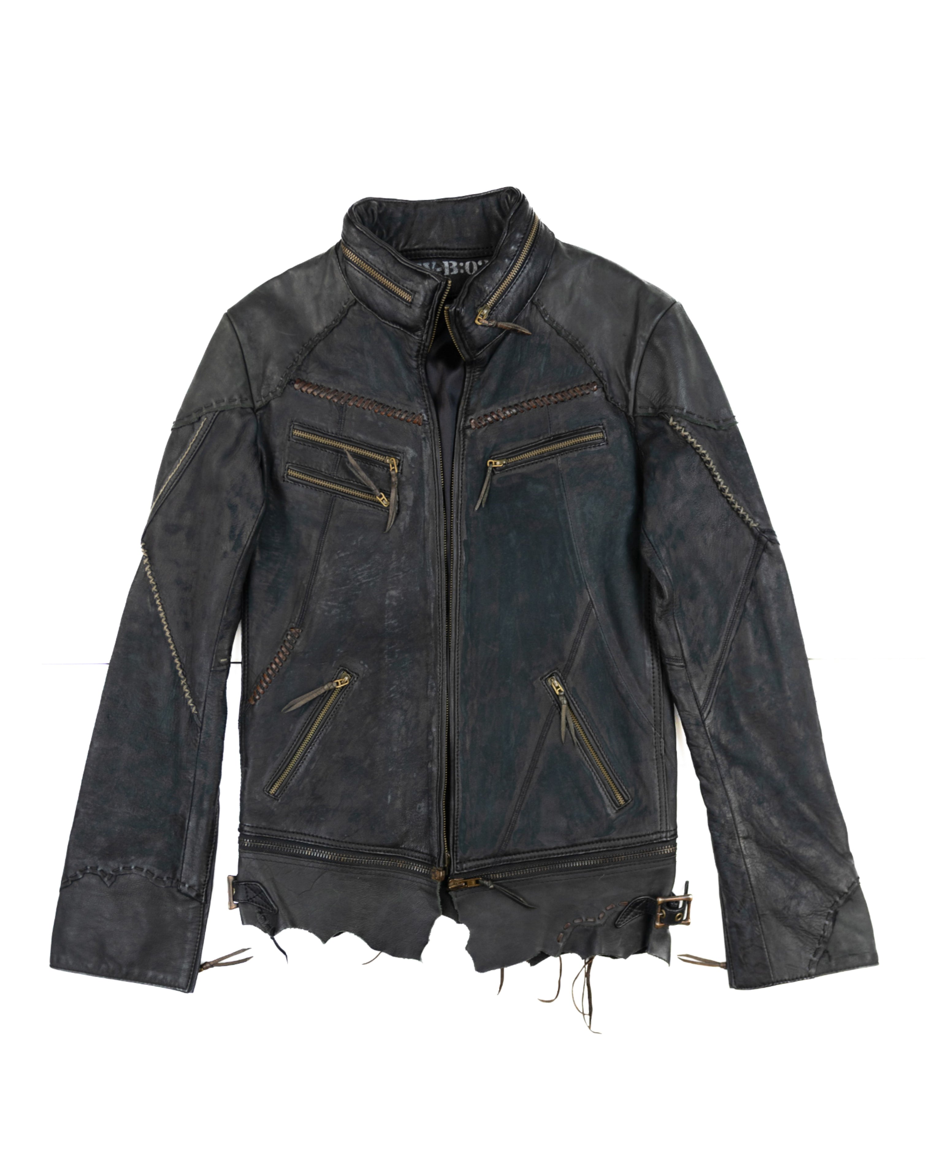 Black leather jacket with gold zipper details on a white background. Vintage 14th Addiction “JK Desert” black/charcoal leather jacket — Japanese artisanal label (Tokyo) known for hand-dyed, hand-distressed rock/avant-garde leathers; moto/biker/rider silhouette with stand collar, braided/whipstitch seams, paneled construction, multiple brass zip pockets, raw shredded hem and worn patina; unisex grunge/goth/punk edge; rare collectible outerwear.
