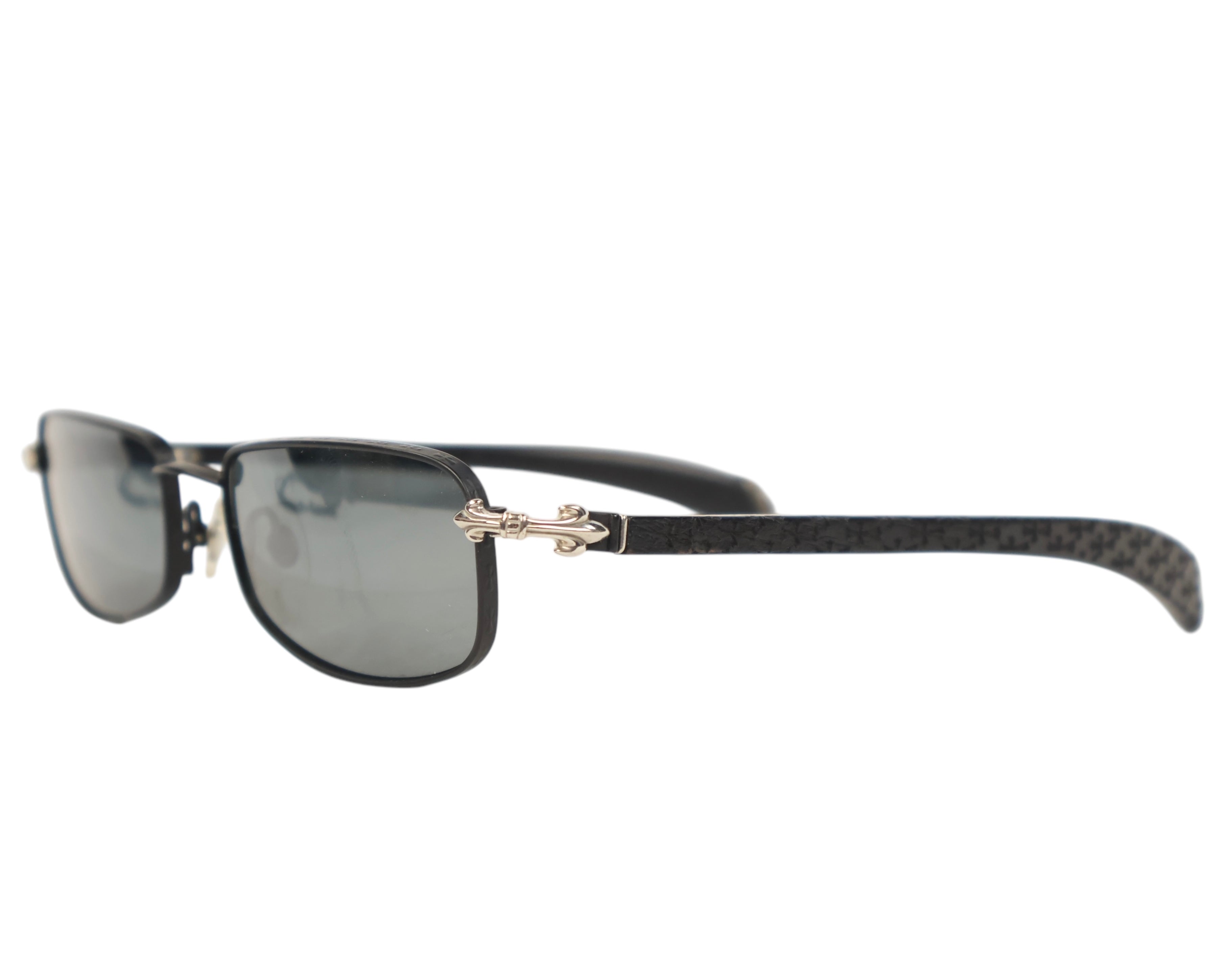 Chrome Hearts luxury sunglasses / shades / eyewear—rectangular oval silhouette with smoke-grey lenses; black genuine wood frame with visible grain; signature sterling-silver fleur-de-lis hinge hardware and rivets; adjustable nose pads and sculpted temples; handcrafted premium materials. Brand context: Chrome Hearts is an American luxury house from Los Angeles (founded 1988) known for artisanal, gothic rock detailing in silver and many Japan-made frames—collectible, rare limited piece perfect for casual or t