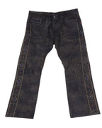Vintage RRL Ralph Lauren 2008 leather pants/trousers in distressed black-brown with a worn patina and straight/bootcut leg. Five-pocket jeans style with jeweled, stud-embellished side stripes and metal hardware—luxury, rare and unique, laid flat on white.