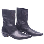 A pair of black leather boots with snakeskin embossing and low heels. Black leather western santiag boots with a pointed toe, side zip and low Cuban heel. Subtle snakeskin inlay motifs on the shaft add a luxury vintage, rare touch.
