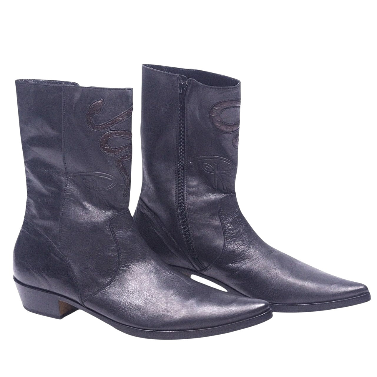 A pair of black leather boots with snakeskin embossing and low heels. Black leather western santiag boots with a pointed toe, side zip and low Cuban heel. Subtle snakeskin inlay motifs on the shaft add a luxury vintage, rare touch.