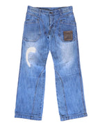 Vintage Kenji Ito “Comme ça Collection” light-blue jeans/denim trousers with workwear patch pockets, a small leather snap pocket, curved seam panels and a straight-leg cut; gently faded with whiskering and a crescent distressed repair, mid-rise with belt loops and button fly, laid flat on white—luxury, rare, utility-inspired.