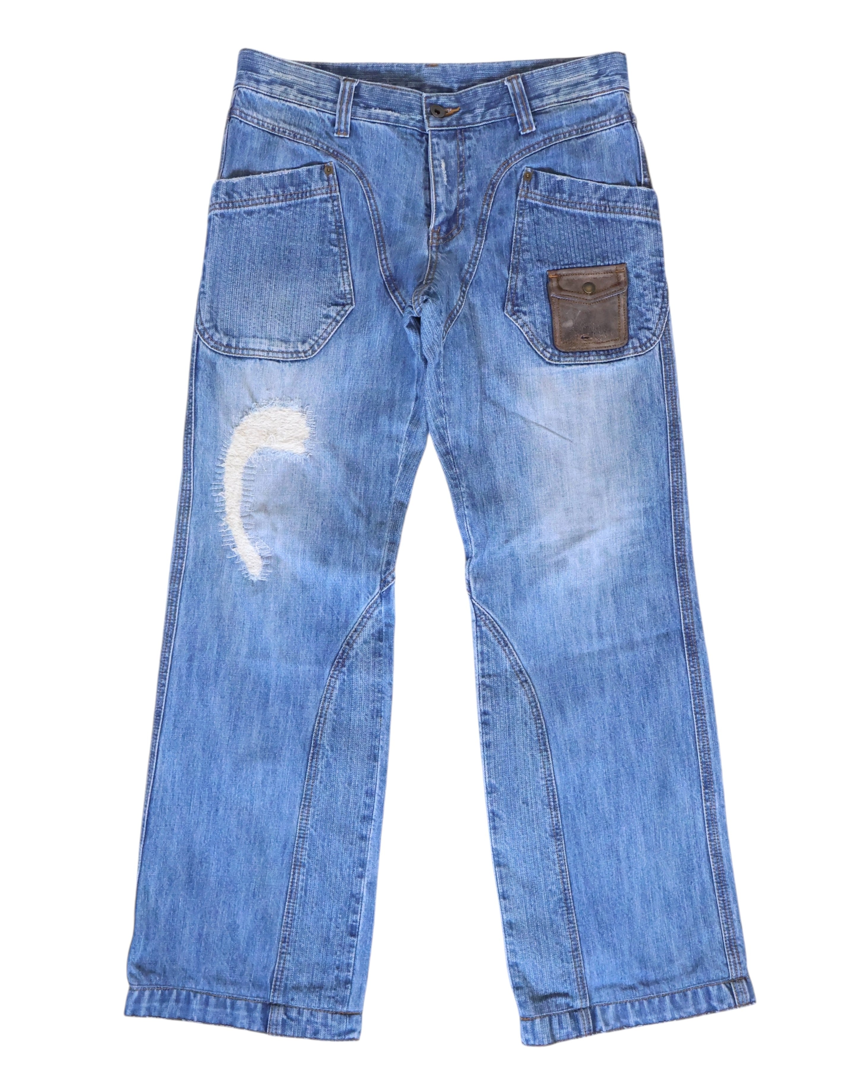 Vintage Kenji Ito “Comme ça Collection” light-blue jeans/denim trousers with workwear patch pockets, a small leather snap pocket, curved seam panels and a straight-leg cut; gently faded with whiskering and a crescent distressed repair, mid-rise with belt loops and button fly, laid flat on white—luxury, rare, utility-inspired.