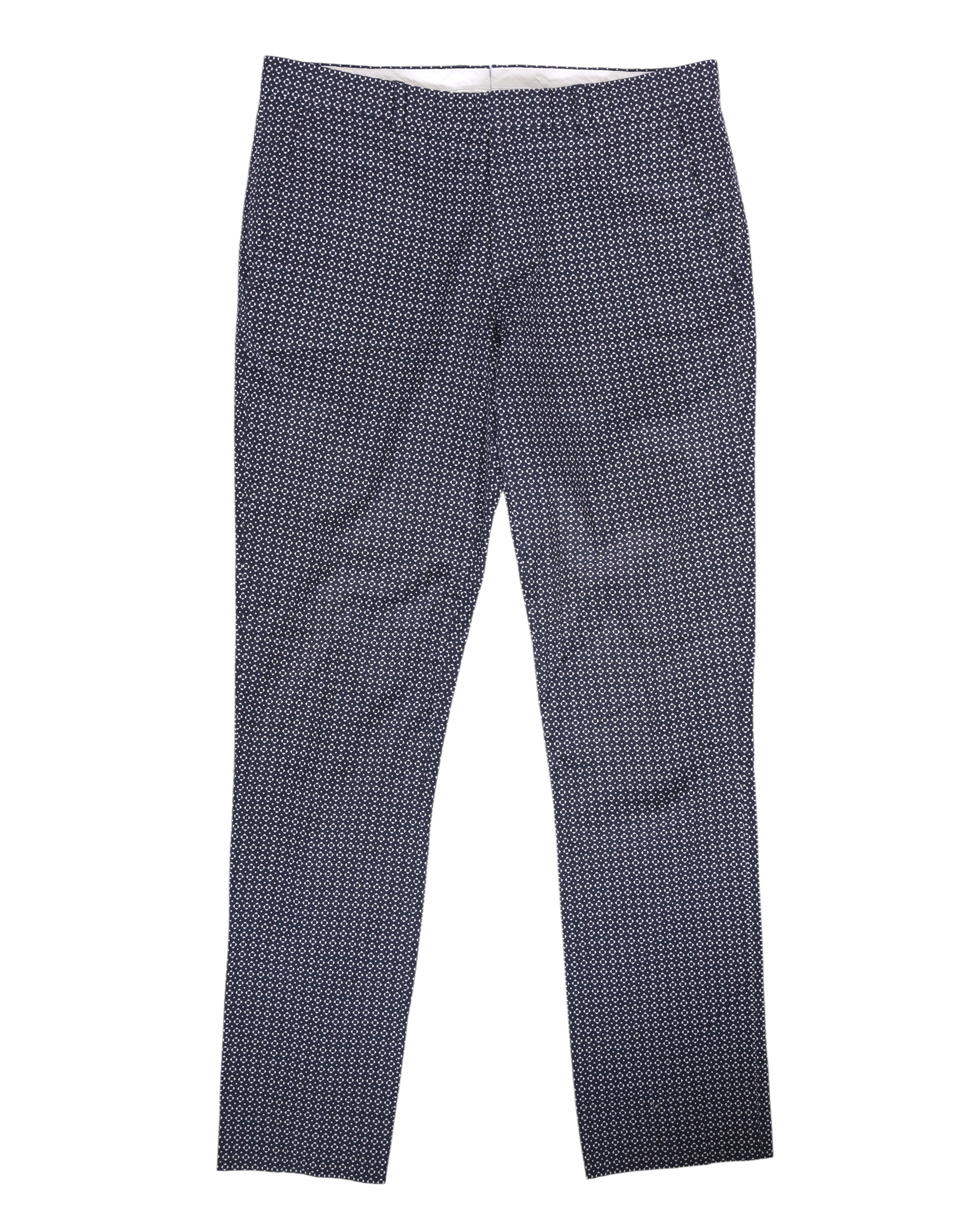 Tailored slim trousers in monochrome black and white with an all-over micro geometric print, smooth woven finish, clean waistband, side pockets and concealed fly. Straight-tapered legs with a retro/mod, designer vibe; second-hand and unique.