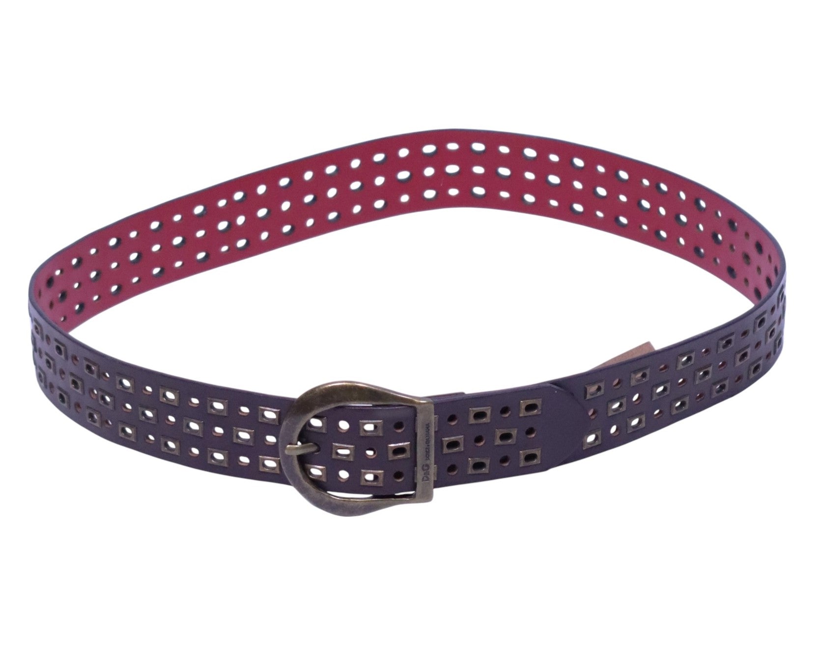 Dolce & Gabbana two-tone perforated leather belt—Italian luxury house from Milan; artisan calfskin strap with eggplant/purple exterior and berry/magenta interior, all-over punched holes (mix of square and round eyelets) revealing the contrast color; aged brass rounded buckle with keeper, adjustable length, burnished edges, durable stitching; designer statement waist belt for men or women, perfect with jeans, trousers, dresses or tailoring; vintage Y2K vibe, bold color pop, collectible and rare.