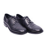 A pair of Christian Dior black leather dress shoes with lace-up closure.Christian Dior black leather lace-up derby shoes with a smooth, slightly glossy finish, round toe and low heel. Minimalist dress shoes with open lacing and a sturdy sole; vintage, high-end, rare.