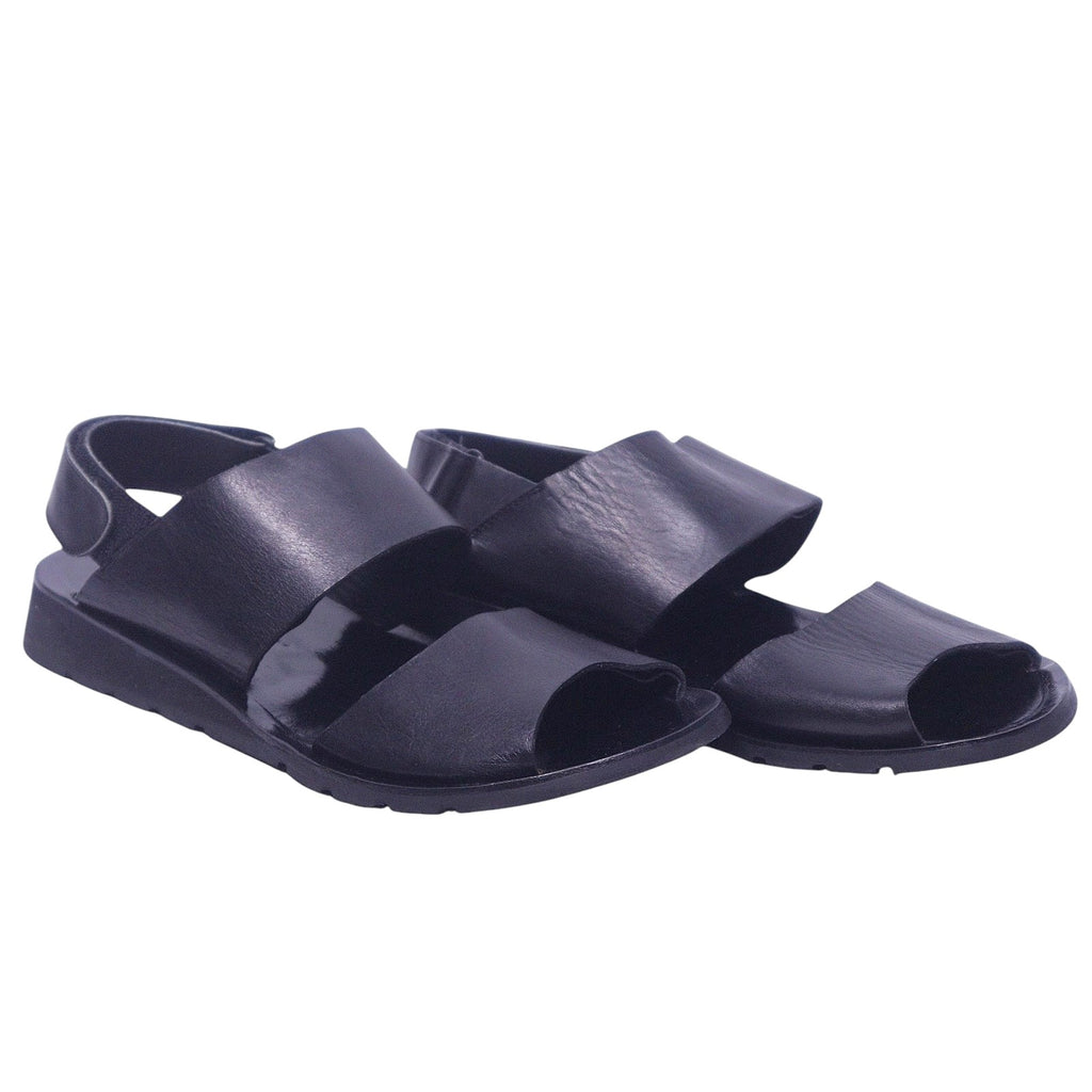 A pair of Yohji Yamamoto black leather strap sandals. Yohji Yamamoto men’s black leather sandals with wide straps, open toe, back strap, and rubber sole.