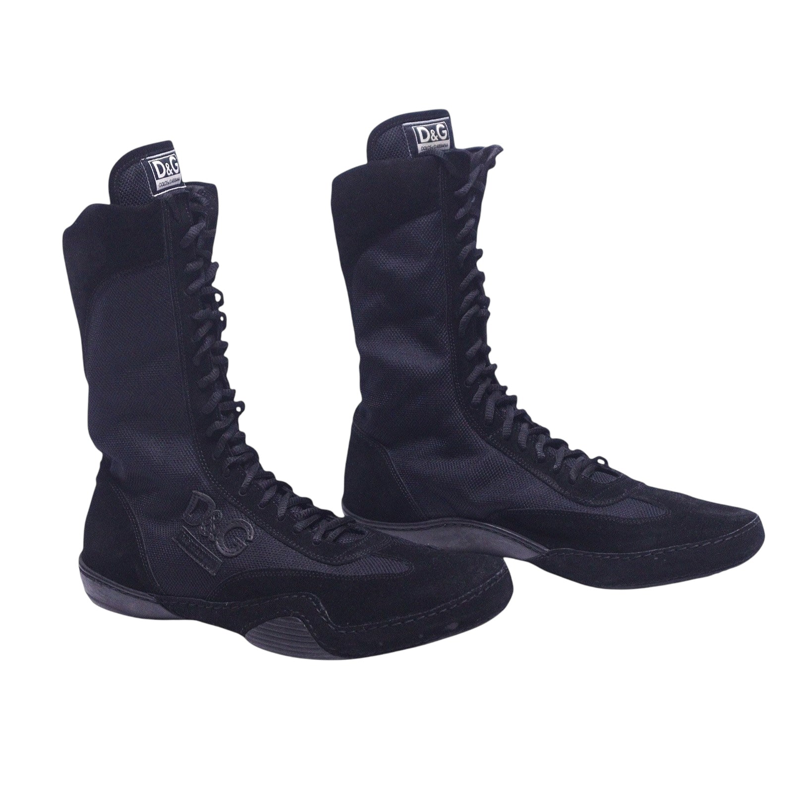A pair of black high-top Dolce Gabbana boxing shoes with lace-up closure. Dolce & Gabbana black high-top boxing sneakers with long lace-up front, slim round toe and textured suede/mesh panels; logo tongue tabs and grippy rubber soles. Vintage designer pair, rare and collectible.