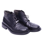 A pair of Versace Jeans couture black leather boots with lace-up closure. Versace Jeans Couture black leather ankle boots with open-lace derby front, round toe and chunky rubber sole. Quilted fabric collar and a small metal logo tag at the laces; vintage designer, rare.