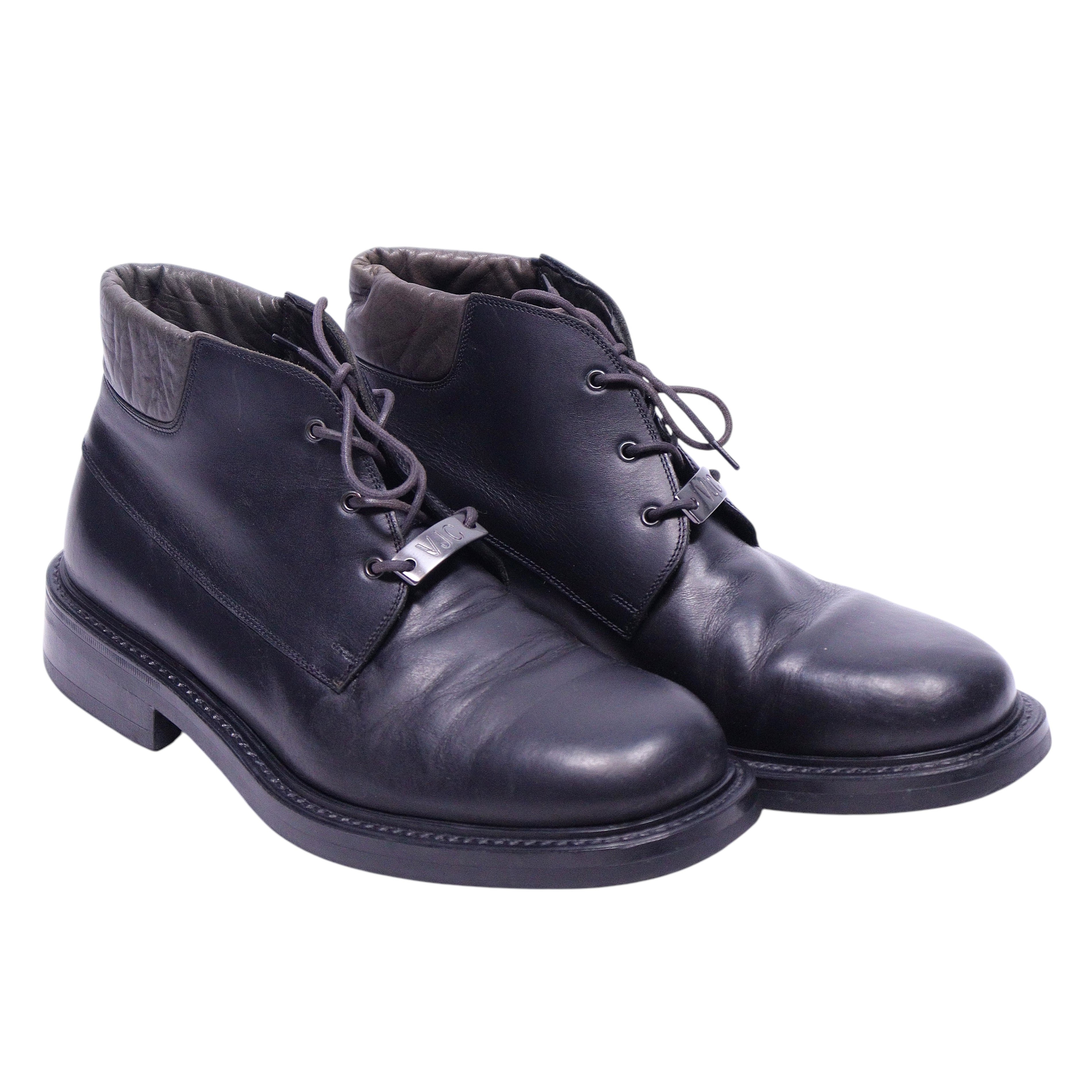 A pair of Versace Jeans couture black leather boots with lace-up closure. Versace Jeans Couture black leather ankle boots with open-lace derby front, round toe and chunky rubber sole. Quilted fabric collar and a small metal logo tag at the laces; vintage designer, rare.