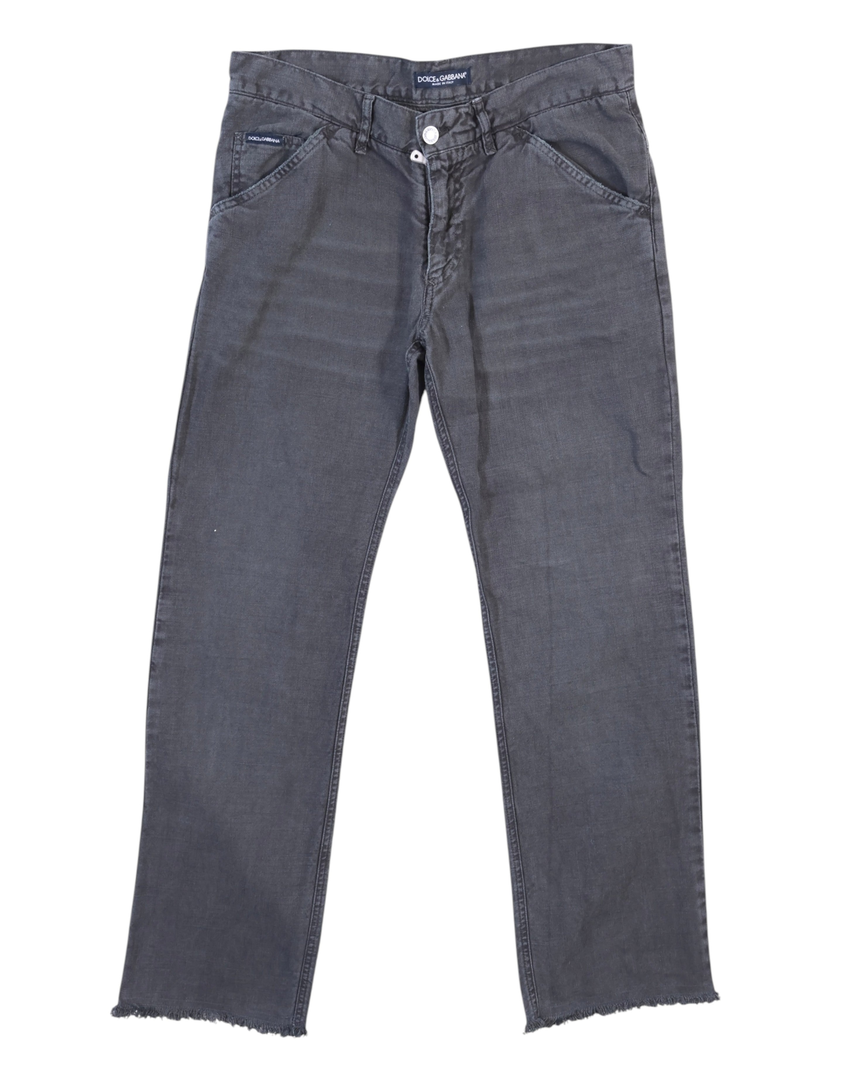 Vintage Dolce & Gabbana dark-gray jeans/denim trousers with a washed finish; mid-rise straight-leg cut, slanted front pockets, belt loops and button front, subtle fading and raw frayed hems. High-end designer piece, rare and unique, laid flat on a white background.