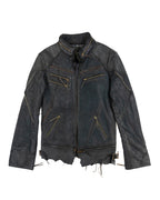 Black leather jacket with gold zipper details on a white background. Vintage 14th Addiction “JK Desert” black/charcoal leather jacket — Japanese artisanal label (Tokyo) known for hand-dyed, hand-distressed rock/avant-garde leathers; moto/biker/rider silhouette with stand collar, braided/whipstitch seams, paneled construction, multiple brass zip pockets, raw shredded hem and worn patina; unisex grunge/goth/punk edge; rare collectible outerwear.
