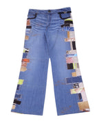 A pair of Roberto Cavalli patchwork denim jeans with various colorful fabric patches. Roberto Cavalli light blue patchwork denim jeans with multicolor fabric panels along both outer legs, black-trimmed pockets and gentle whiskering. Relaxed straight leg, five-pocket style with belt loops and zip fly; vintage designer, rare statement pair.