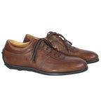 Sergio Rossi brown leather low-top sneakers with round toe, stitched paneling, side perforation details, and rubber sole.