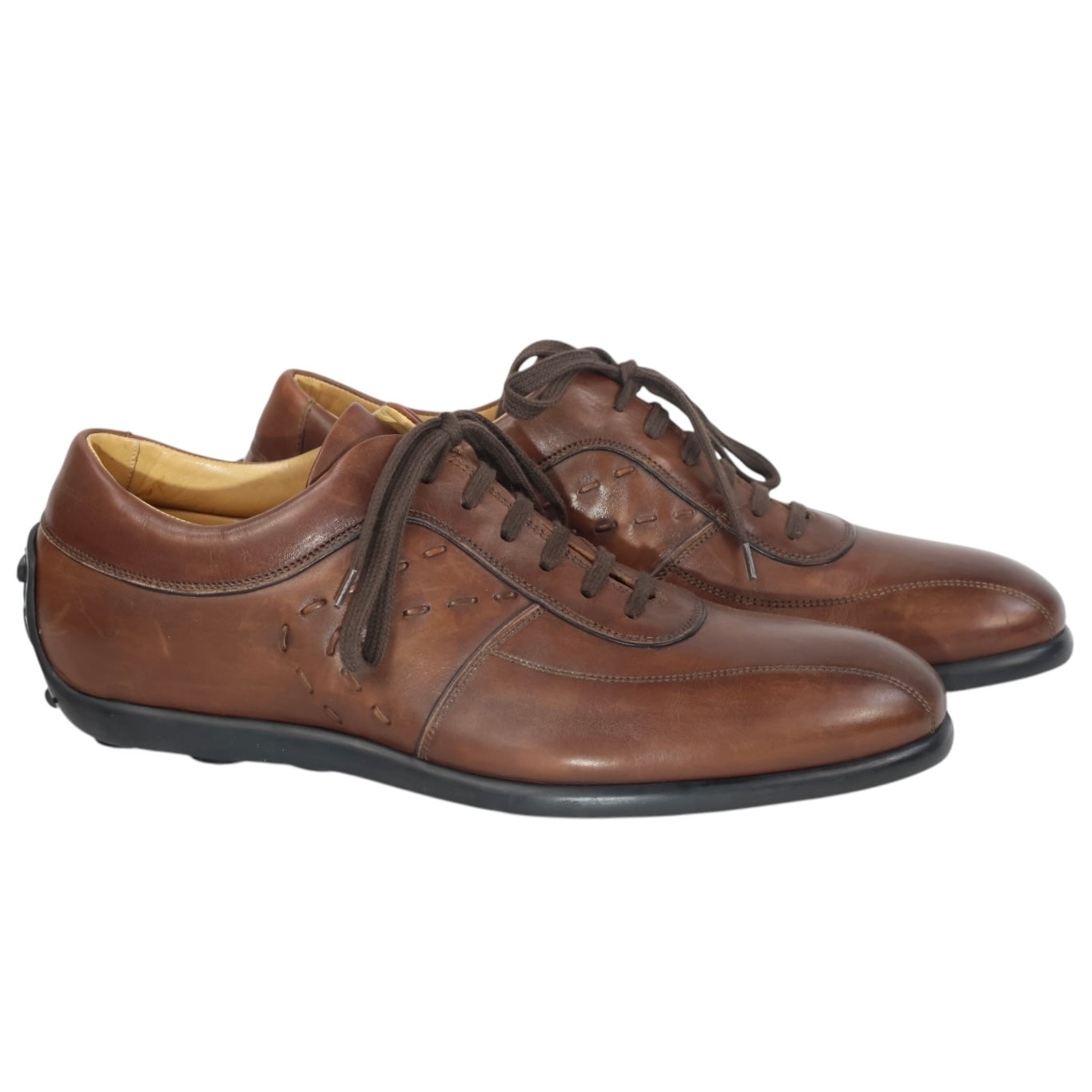 Sergio Rossi brown leather low-top sneakers with round toe, stitched paneling, side perforation details, and rubber sole.