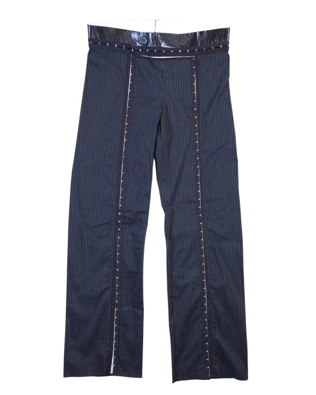 Vintage Denis Gagnon navy pinstripe trousers/pants in suiting fabric with a glossy patent-style waistband and double buttons, straight-leg cut. Front vertical trim panels with contrast ladder stitching add avant-garde tailoring; rare luxury piece laid flat on white. Quebec vintage fashion, Montreal vintage clothing