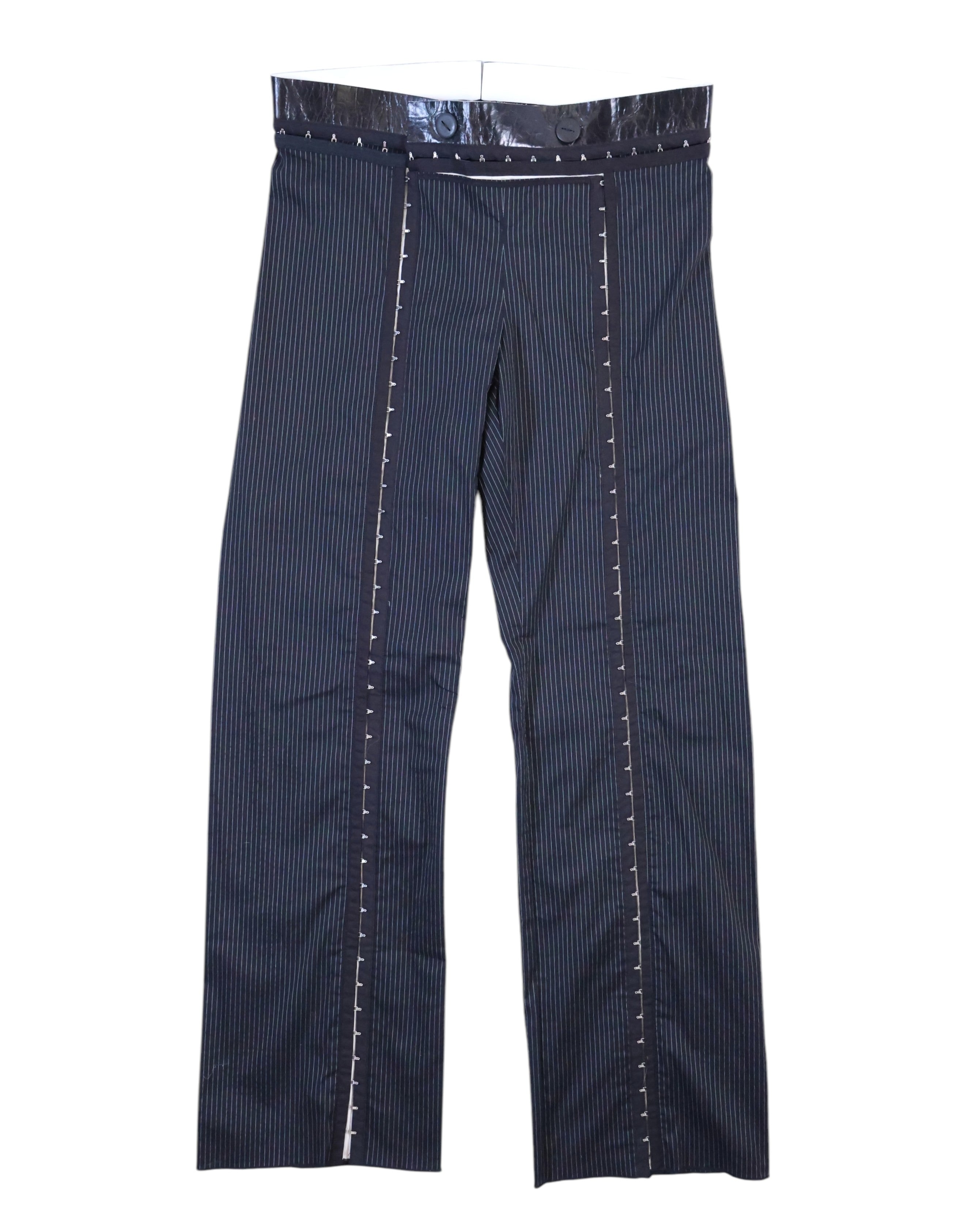 Vintage Denis Gagnon navy pinstripe trousers/pants in suiting fabric with a glossy patent-style waistband and double buttons, straight-leg cut. Front vertical trim panels with contrast ladder stitching add avant-garde tailoring; rare luxury piece laid flat on white. Quebec vintage fashion, Montreal vintage clothing