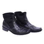 A pair of black python leather chelsea boots by Roberto Cavalli. Roberto Cavalli black snake-textured leather Chelsea boots with elastic side panels, square apron toe and low stacked heel; reptile-scale finish, vintage designer, rare.