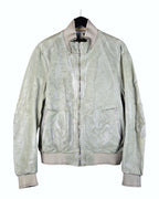 A green leather jacket with a mandarin collar, zipper front, and elastic cuffs, Vintage Carol Christian Poell S/S 2005 sage-green leather jacket—archival avant-garde bomber/blouson with rib-knit collar, cuffs and hem; front zip, zipped hand pockets, articulated elbow seam details, tonal top-stitching; washed pale olive/sage patina, supple genuine leather; Italian/European artisanal construction from the cult Austrian-born designer; unisex, rare collector piece, perfect for layering, streetwear to tailoring.