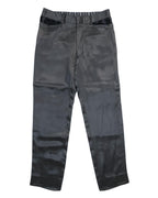 Vintage Matsuda Nicole (Tokyo) black trousers in lustrous satin-like fabric, flat front with cropped straight leg and clean hems. Minimalist tailored style with contrast glossy waistband tabs and belt loops; rare, high-end designer piece laid flat on white.