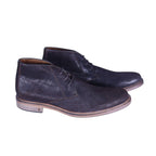 A pair of brown leather chukka boots with a lace-up closure. John Varvatos dark brown leather chukka boots with three-eyelet lacing, almond toe, contrast welt and stacked sole; lightly distressed finish—vintage, luxury, rare.