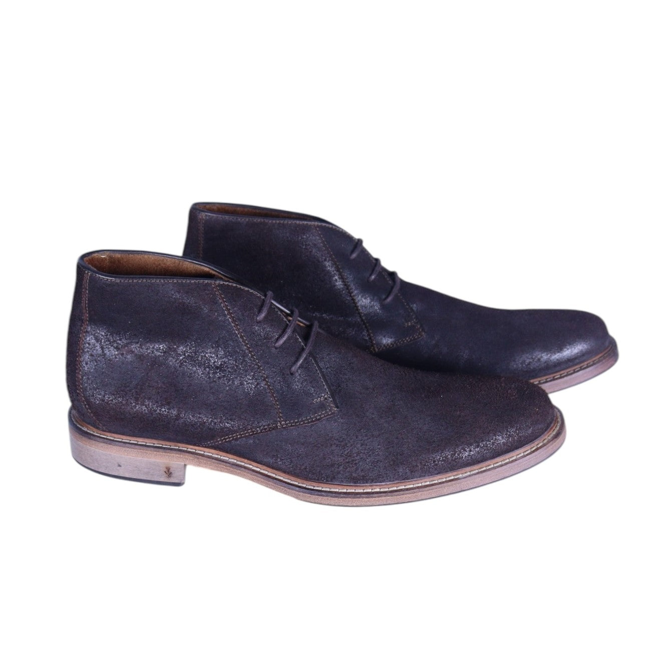 A pair of brown leather chukka boots with a lace-up closure. John Varvatos dark brown leather chukka boots with three-eyelet lacing, almond toe, contrast welt and stacked sole; lightly distressed finish—vintage, luxury, rare.
