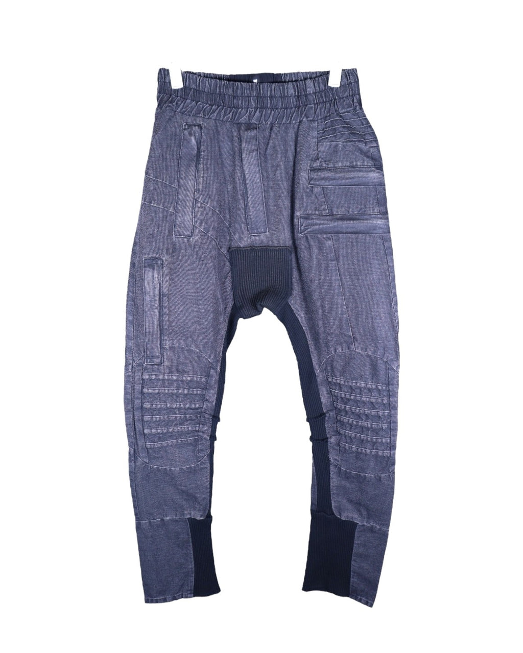 Vintage second-hand Demobaza charcoal-grey sweatpants/joggers in soft knit with a drop-crotch and tapered cuffed legs, elastic drawstring waist, ribbed insets at crotch and hems, moto-quilted knee panels and multi-seam patchwork. Avant-garde techwear/utility style, luxury designer and unique, laid flat on white.