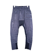 Vintage second-hand Demobaza charcoal-grey sweatpants/joggers in soft knit with a drop-crotch and tapered cuffed legs, elastic drawstring waist, ribbed insets at crotch and hems, moto-quilted knee panels and multi-seam patchwork. Avant-garde techwear/utility style, luxury designer and unique, laid flat on white.
