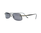 A pair of rimless sunglasses with dark lenses and metallic frame. Kata sunglasses / shades / eyewear — rimless drill-mount design with smoke-grey lenses, sleek metal/titanium bridge, ultra-thin wire temples with rubberized sleeves; lightweight, minimalist, unisex fit. Brand context: Kata is a design-led eyewear label rooted in Japanese minimalism and precision engineering, known for lightweight titanium pieces often crafted in Japan—collectible luxury sunglasses.