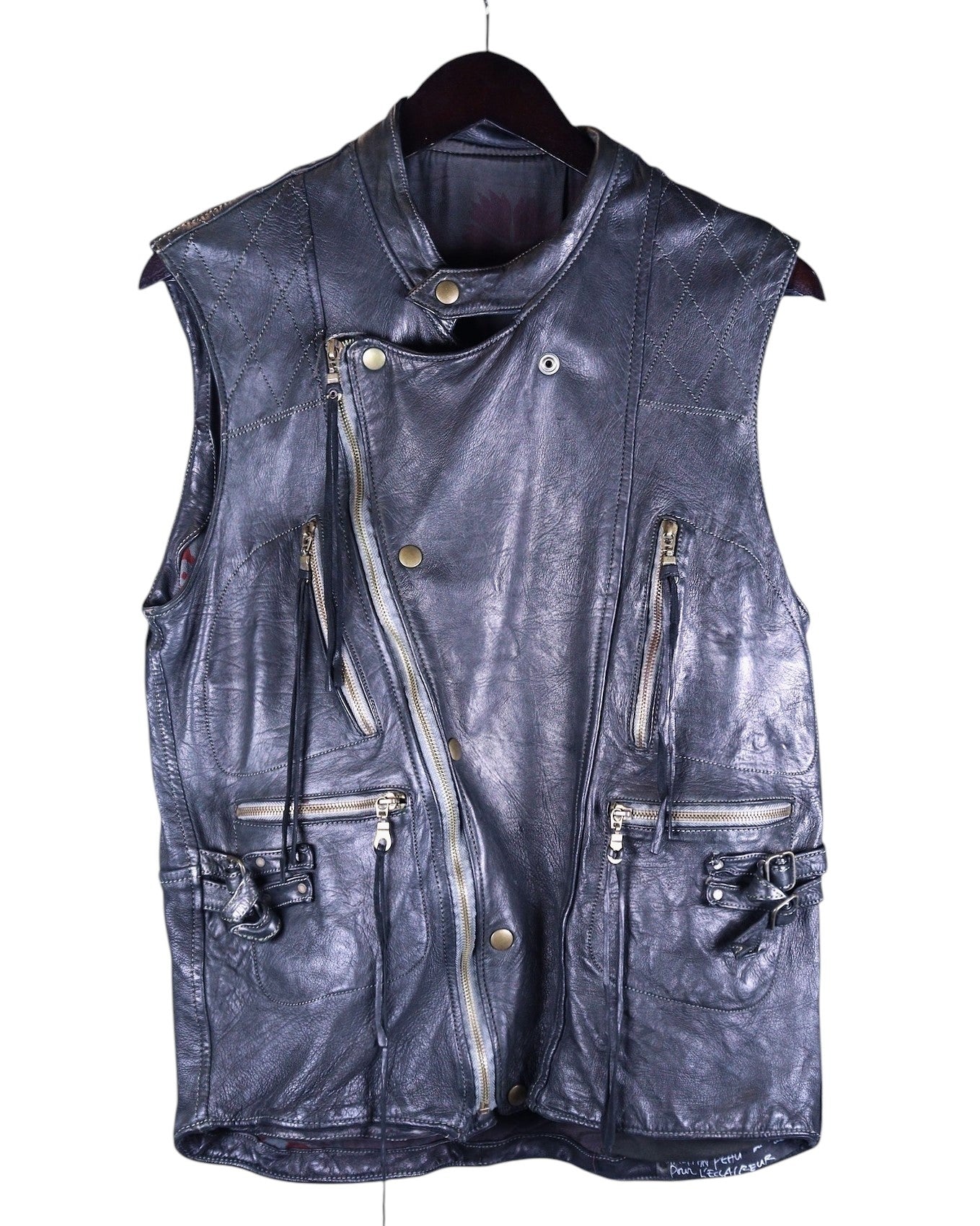 zippered front, and multiple pockets. Christian Peau black leather moto vest / biker gilet / sleeveless jacket / waistcoat—hand-dyed, distressed patina, asymmetrical zip front, snap stand collar, diamond-stitched shoulders, multiple zip pockets, buckle straps and hardware, artisan construction, vintage workwear meets avant-garde. Japanese label from Kyoto known for small-batch leather craftsmanship and old-world techniques; unisex styling for layering over tees, shirts, or knits.