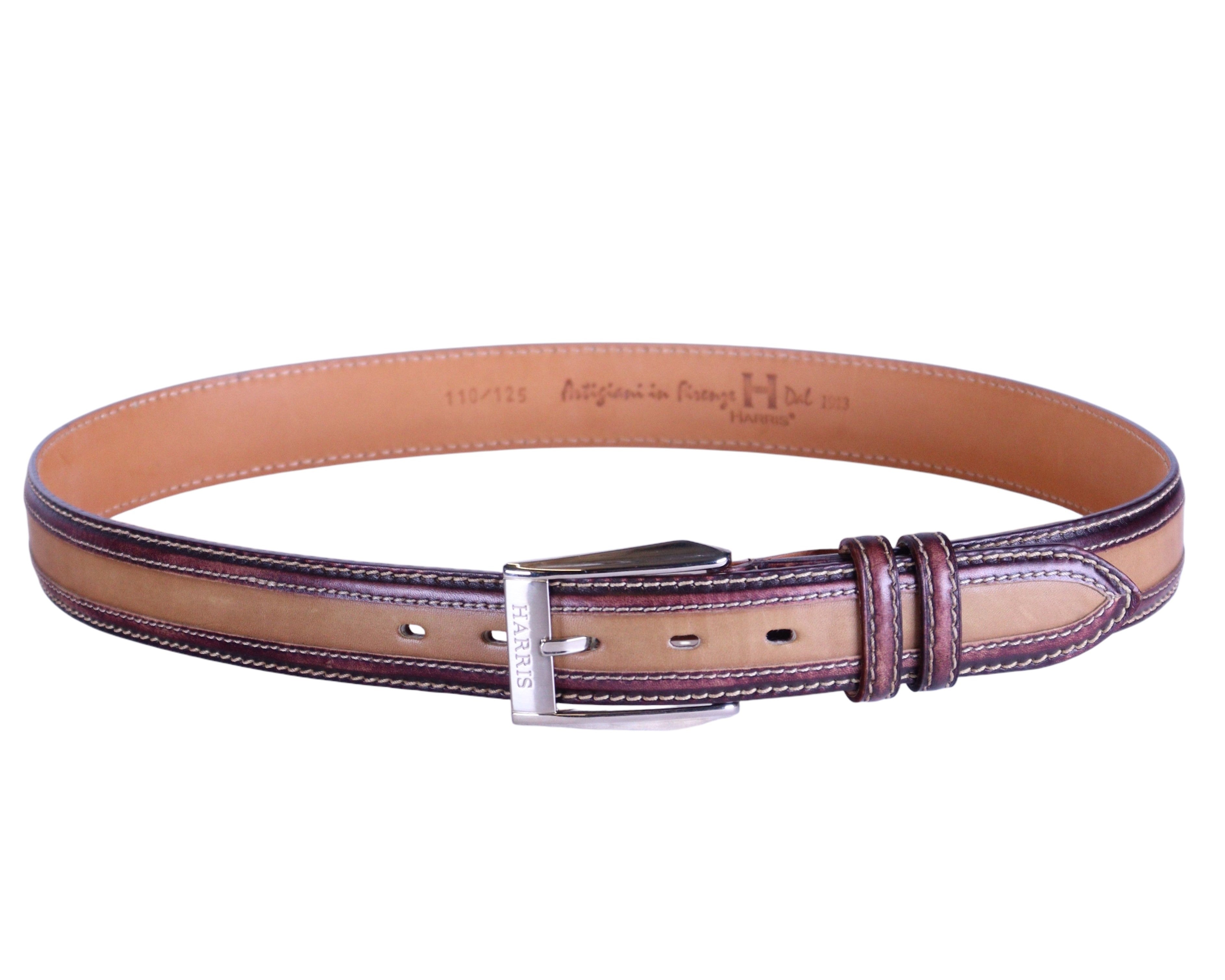 A brown genuine leather belt with a metal buckle and contrasting stitching, made in Italy. Harris two-tone brown/tan/cognac calfskin leather belt; contrast top-stitching and edge piping; polished silver-tone engraved buckle, double keepers; classic narrow strap, unisex; perfect with jeans, chinos, or tailoring; style tags: heritage, smart casual, dress belt, Italian luxury; brand context: Italian artisanal leather label from Tuscany/Florence, hand-finished.