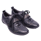 A pair of black Just Cavalli leather sneakers with snake-embossed patterns and studded details. Black low-top sneakers with snake-embossed panels, lace-up front and rounded toe, dotted with small gold studs and a logo strap across the tongue. Mixed-texture leather with a low rubber sole; vintage designer, rare.