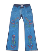 A pair of blue jeans with a floral paint design and decorative paint details. Bright blue straight-leg pants with hand-painted floral and bird motifs, front flap pockets and a contrast waistband. Side snap hems add a retro, artisan touch—vintage, rare designer.