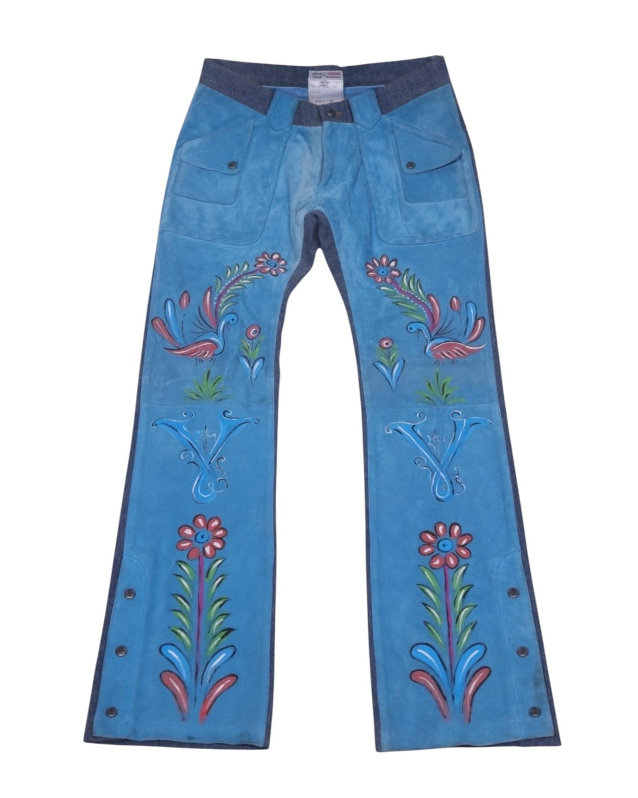A pair of blue jeans with a floral paint design and decorative paint details. Bright blue straight-leg pants with hand-painted floral and bird motifs, front flap pockets and a contrast waistband. Side snap hems add a retro, artisan touch—vintage, rare designer.