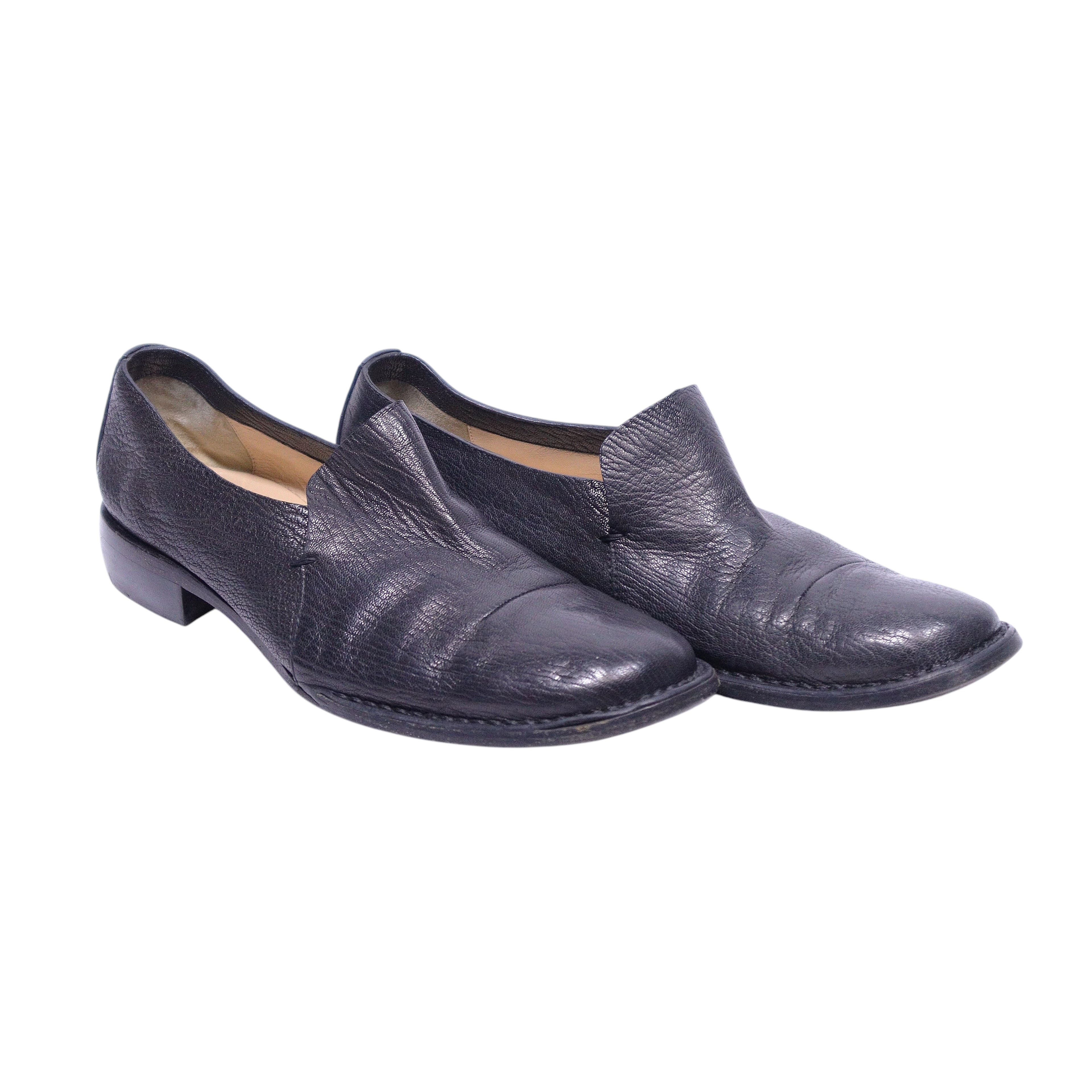 A pair of black leather loafers. Costume National black leather loafers with split-vamp, center seam and almond toe; slip-on style with low stacked heel and clean apron. Italian minimalist, vintage luxury, rare.