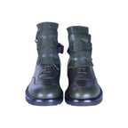 A pair of green leather boots with a Medusa head design on the side, lace-up front, and a chunky sole. Versace green leather combat boots with oversized tongues embossed with the Medusa head, lace-up fronts, side buckle straps, and chunky black soles.