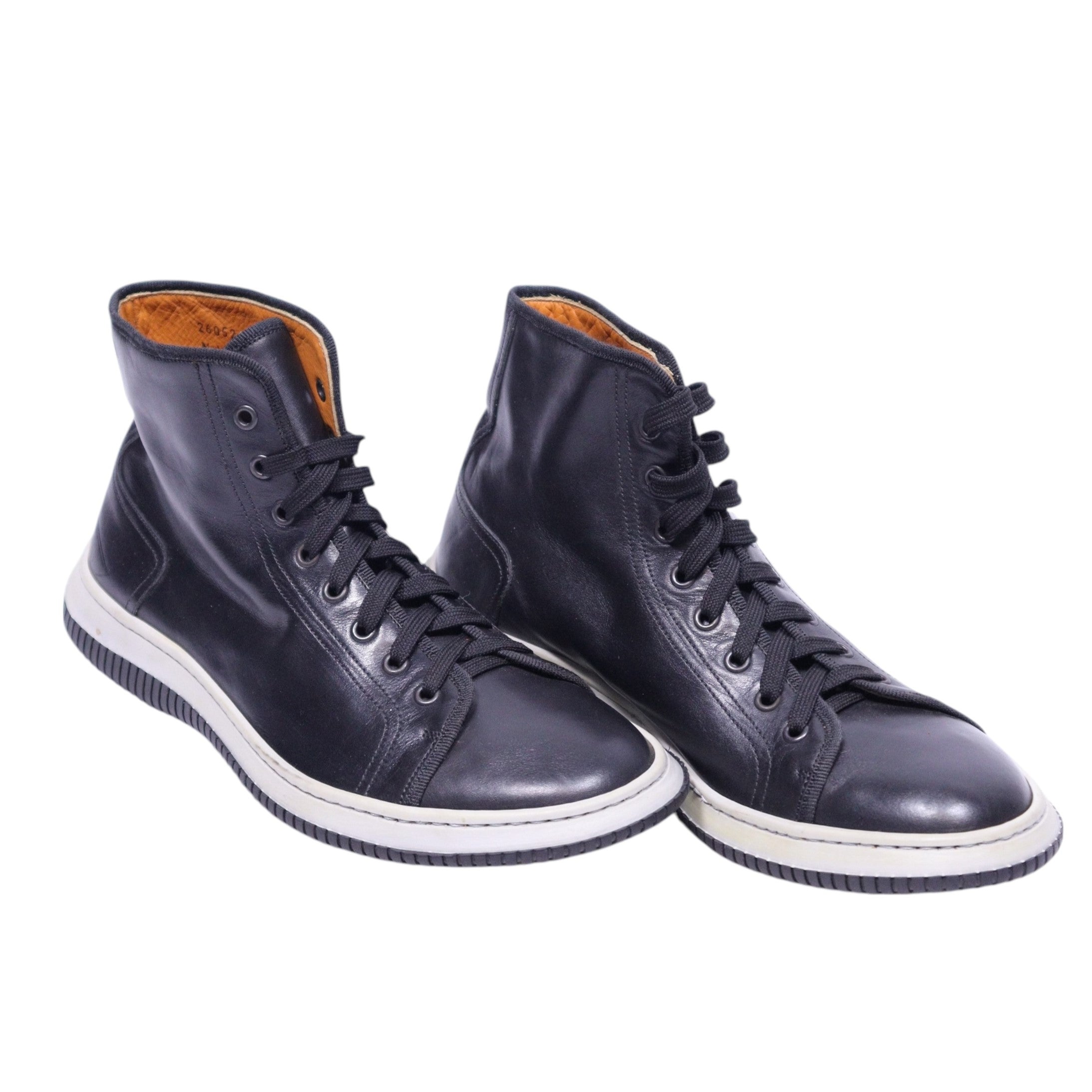 A pair of Gianfranco Ferre high-top leather sneakers with lace-up closure, displaying a black upper, white sole, and brown interior lining. Vintage Gianfranco Ferré black leather high-top sneakers/trainers — lace-up ankle shoes with round toe, padded collar, tan leather lining and contrast white rubber sole; minimalist Italian designer streetwear.
