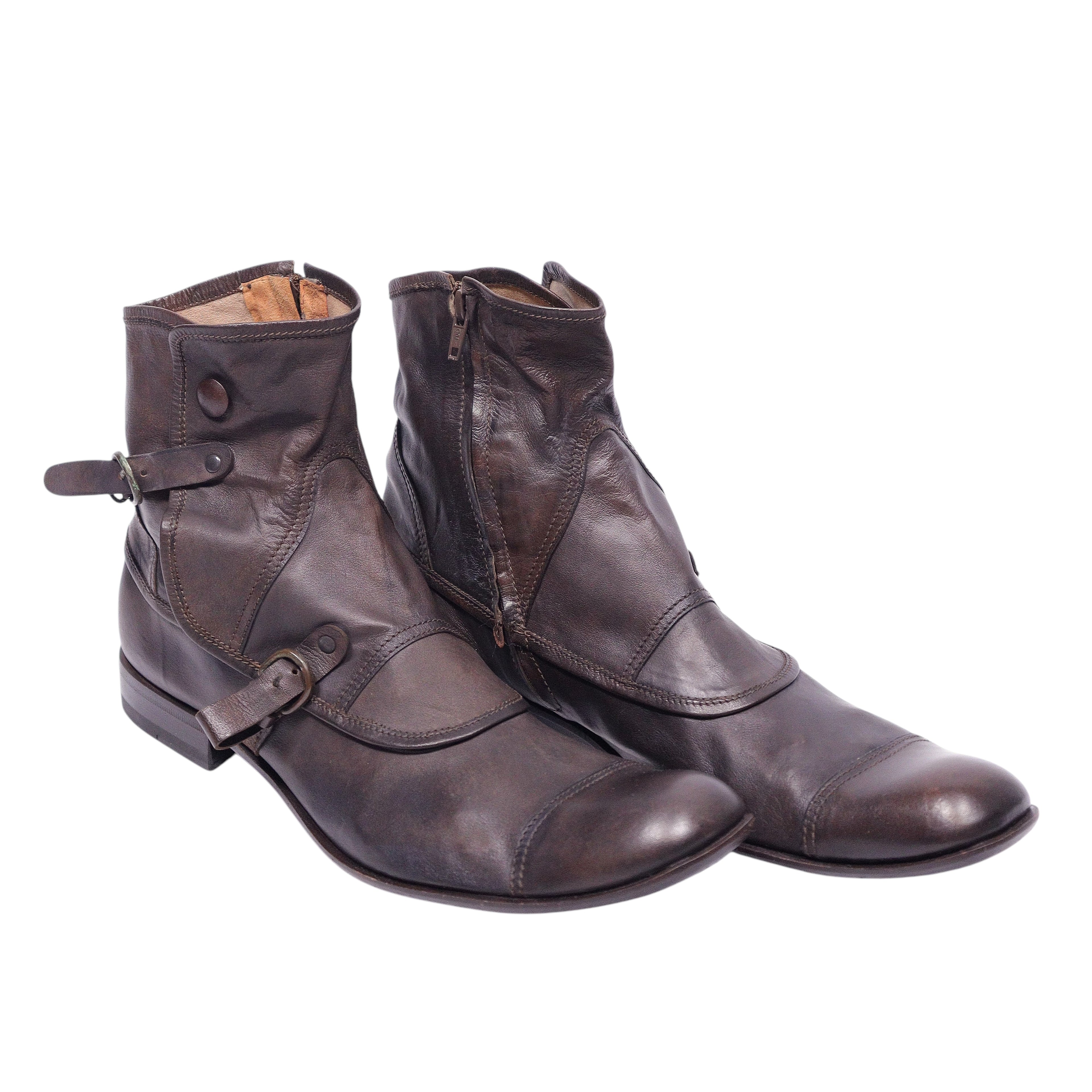 A pair of brown Gianni Barbato leather boots with buckled straps and a zipper. Vintage Gianni Barbato brown leather ankle boots with buckle straps and side zippers; round cap-toe, layered panels, low stacked heel, distressed patina—Italian artisan rocker/western style (men’s or unisex).