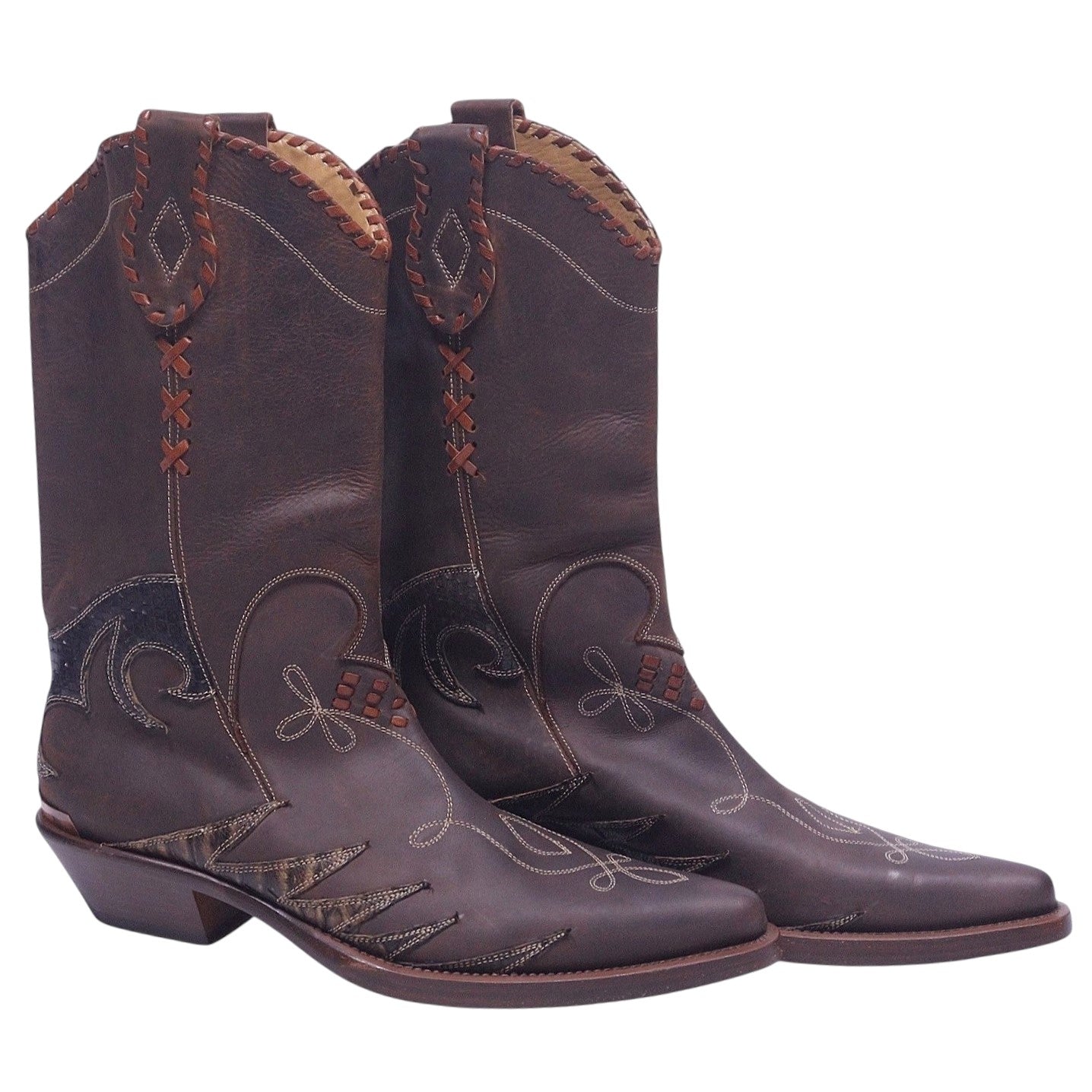 A pair of brown leather boots with snakeskin and embroidered details. Roberto Cavalli brown leather Western santiag boots with snakeskin inlays, contrast embroidery, whipstitch shaft details, pull-on style, pointed toe and stacked Cuban heel.