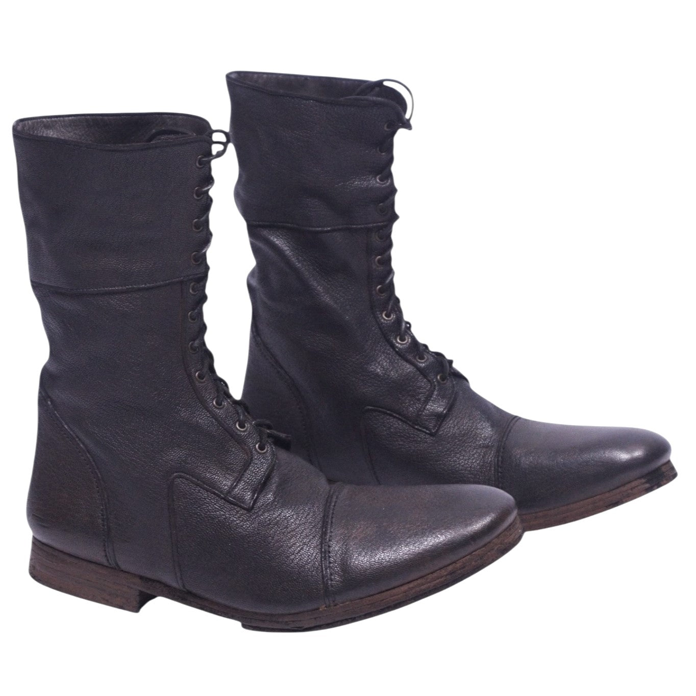 A pair of dark brown leather boots with a lace-up front and a low heel on a plain background. Christian Peau dark brown leather lace-up boots with a mid-calf shaft, round cap toe and low stacked heel. Grained leather with vintage, rugged patina; artisanal, designer, rare.
