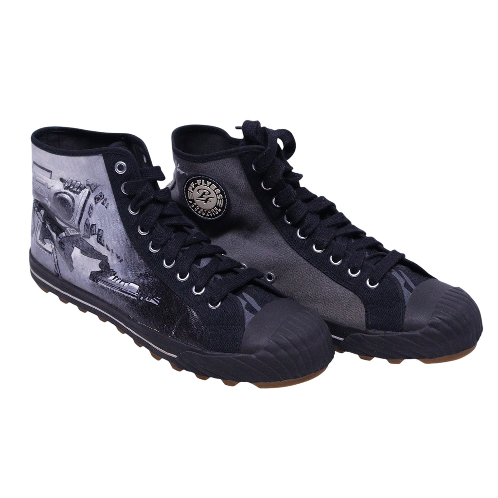 A pair of high-top PF Flyers sneakers featuring a black and white design with a graphic of a person on the side. PF Flyers x Justin Bua limited-edition high-top sneakers in black/grey canvas with street-art graphics, rubber toe caps, and lug soles.