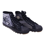 A pair of high-top PF Flyers sneakers featuring a black and white design with a graphic of a person on the side. PF Flyers x Justin Bua limited-edition high-top sneakers in black/grey canvas with street-art graphics, rubber toe caps, and lug soles.