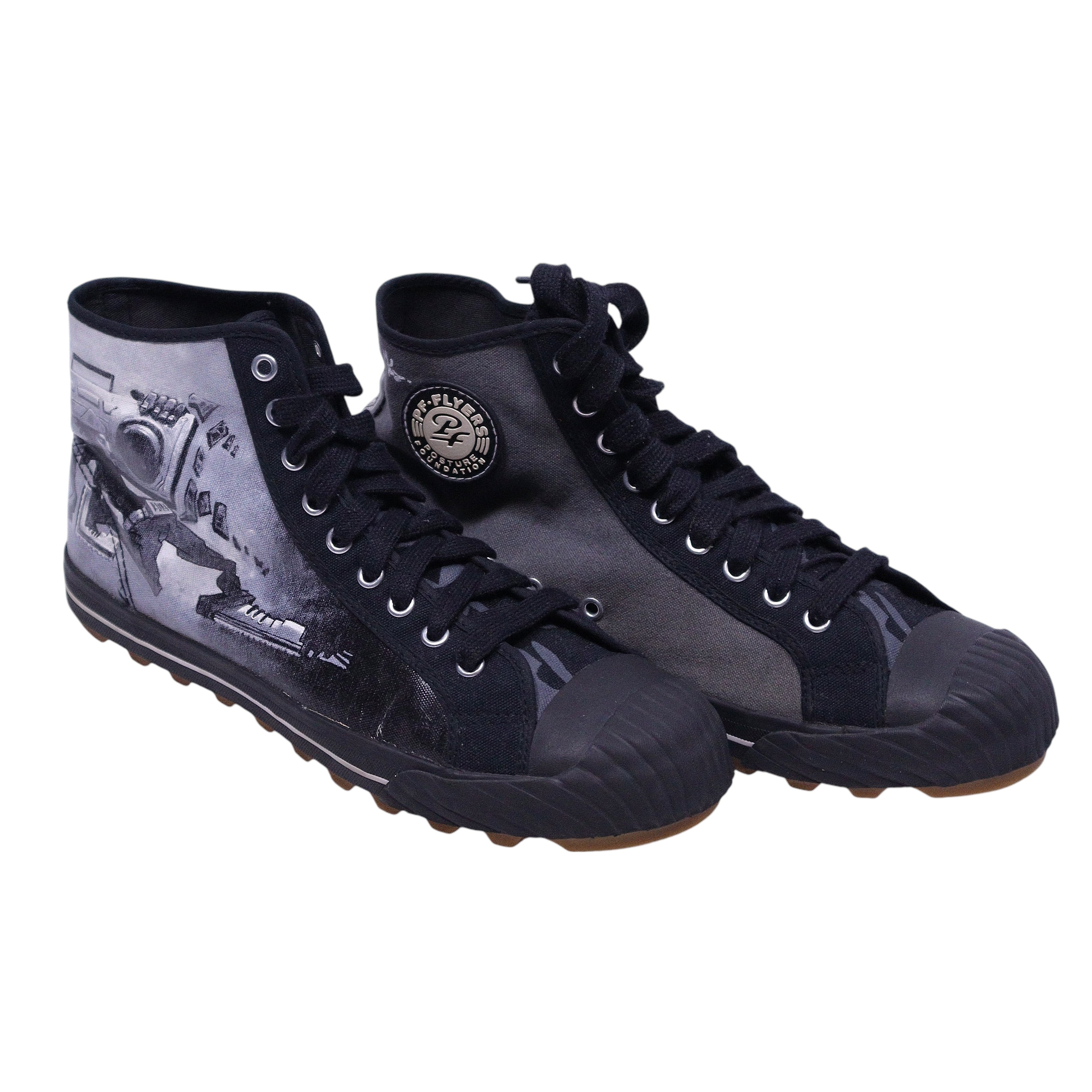 A pair of high-top PF Flyers sneakers featuring a black and white design with a graphic of a person on the side. PF Flyers x Justin Bua limited-edition high-top sneakers in black/grey canvas with street-art graphics, rubber toe caps, and lug soles.