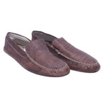 A pair of brown leather moccasin shoes for adults. Roberto Cavalli brown leather moccasin loafers with hand-stitched moc-toe apron, slip-on design, and low profile.