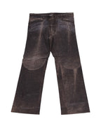 A pair of brown leather pants laid flat on a white background, showing the front view with pockets and belt loops. Vintage Roberto Cavalli dark-brown leather trousers/pants with rich textured grain and jeans-style waistband with belt loops and button waist. Straight/bootcut leg with oversized curved knee/thigh panels and gentle patina—luxury, rare piece laid flat on white.