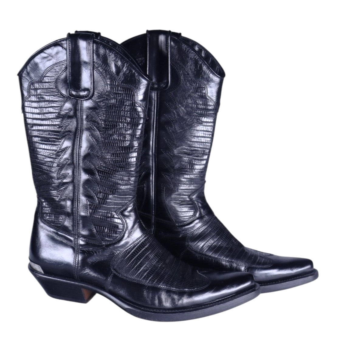 A pair of black leather glossy finish boots with embossed leather design. Roberto Cavalli black leather western Santiag boots with a glossy finish and embossed pattern, pull tabs, pointed toe and low Cuban heel. Vintage designer pair, rare.
