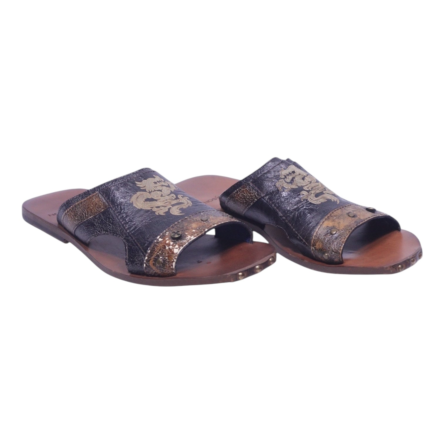 A pair of distressed leather sandals featuring a dragon pattern, predominantly in brown tones. Mark Nason distressed leather slide sandals — men’s open-toe slip-ons with gold dragon motif, wide strap, metal stud details, brown/black vintage finish, leather footbed and sole, rocker style summer sandals.