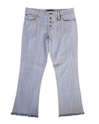 Vintage Roberto Cavalli black-and-white striped jeans/pants in fine pinstripe (railroad stripe) denim; mid-rise button fly, five pockets and belt loops with a small ring detail, slight bootcut legs and fringed/raw hems, laid flat on white. Luxury, rare designer piece.