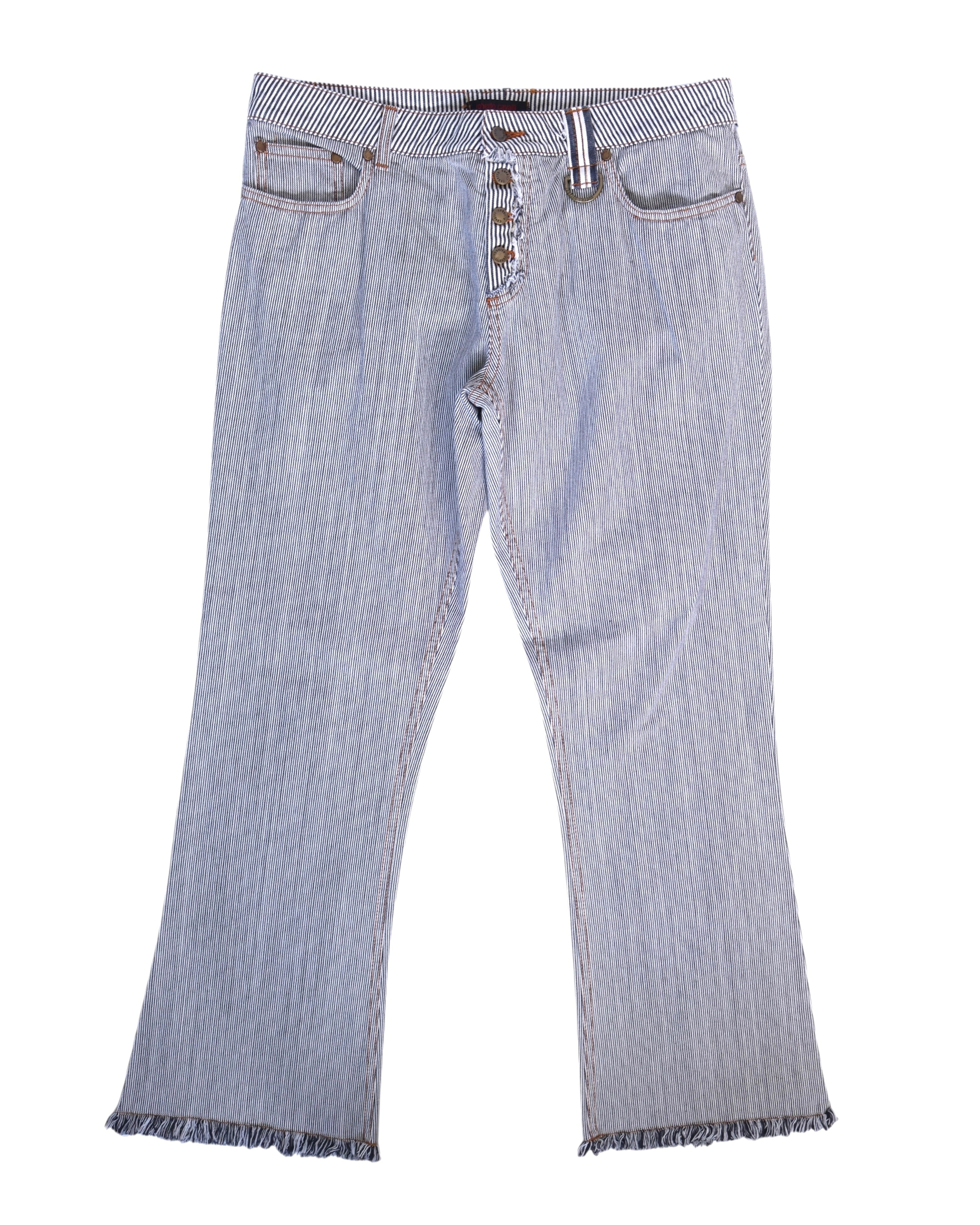 Vintage Roberto Cavalli black-and-white striped jeans/pants in fine pinstripe (railroad stripe) denim; mid-rise button fly, five pockets and belt loops with a small ring detail, slight bootcut legs and fringed/raw hems, laid flat on white. Luxury, rare designer piece.